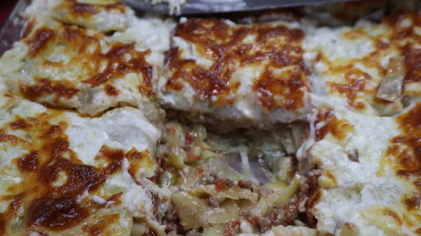 istock Homemade lasagna and melted cheddar background. 1321374731