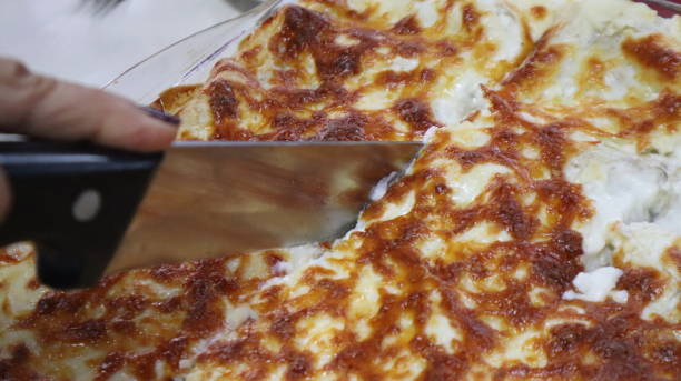 istock Homemade lasagna and melted cheddar background. 1321375006