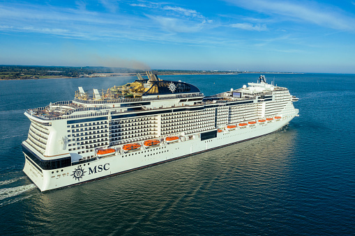 MSC Virtuosa cruise ship leaving Southampton port with passengers.