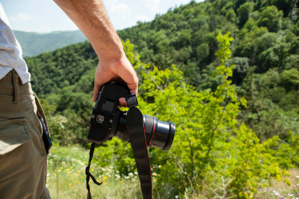 istock photographer holding camera in nature 1321378131