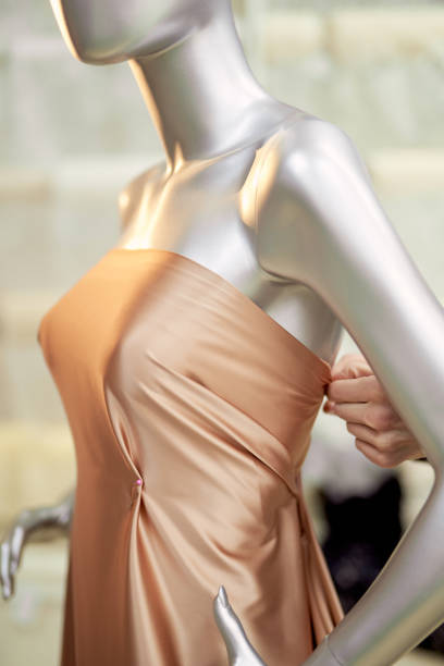 istock Tailor working with mannequin and brown fabrics in atelier 1321378253
