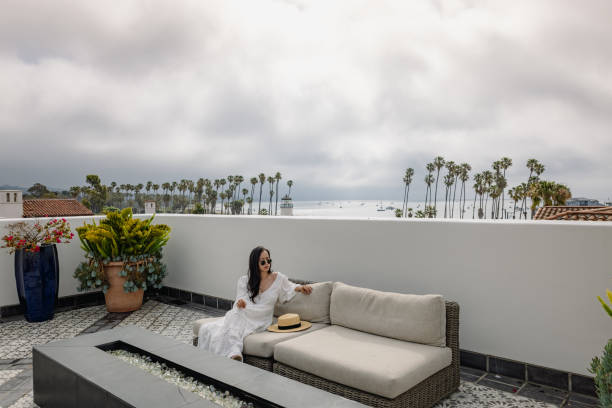 istock Woman sitting on couch enjoying the day 1321379418