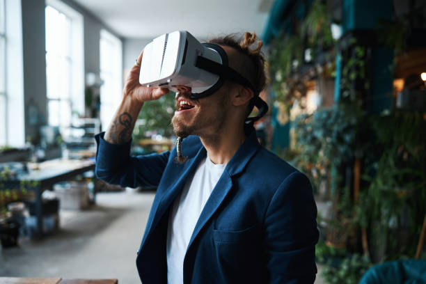 istock Joyful young man wearing virtual reality glasses 1321381320
