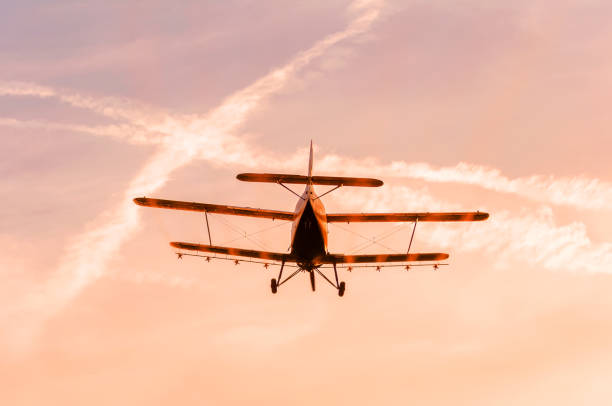 istock View on an old plane flying during the sunset 1321381486