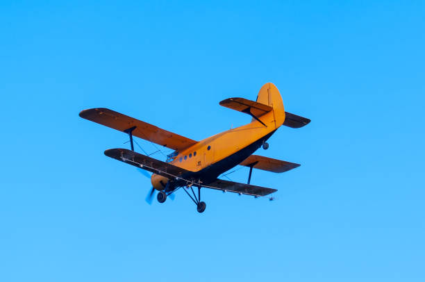istock View on an old plane flying againtst the blue sky 1321381497