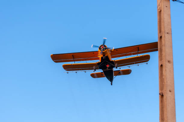 istock View on an old plane flying againtst the blue sky 1321381501