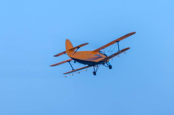 istock View on an old plane flying againtst the blue sky 1321381504