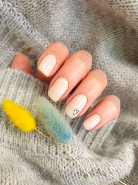 istock female hand beautiful beige manicure sweater 1321382614