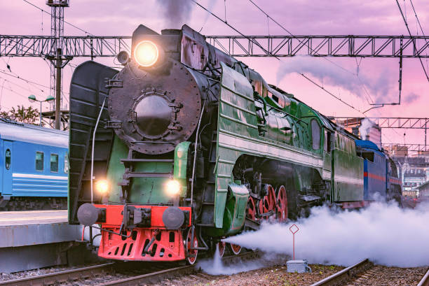 istock Retro train departs from the platform at sunset time. 1321384168