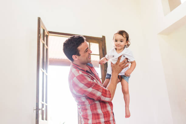 istock father playing with his daughter on his lap 1321396617