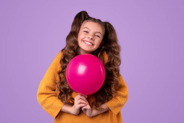 istock Delighted stylish child with balloon 1321401440
