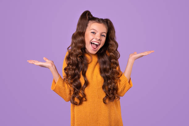 istock Excited cute girl shrugging shoulders 1321401442