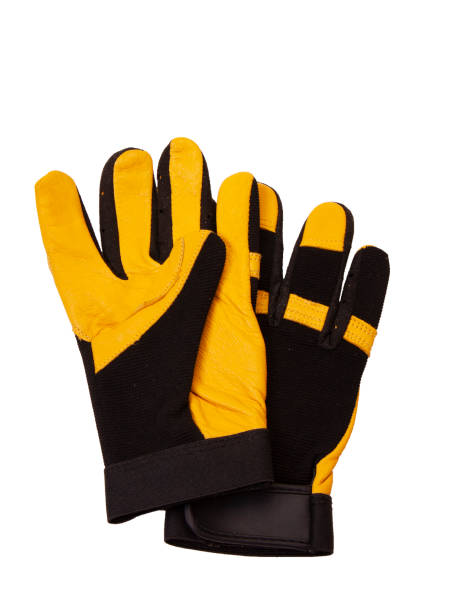 желтые и черные кожаные рабочие перчатки, снятые в студии на белом фоне - glove leather black isolated стоковые фото и изображения