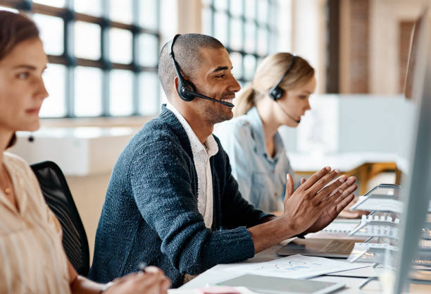 istock Shot of a young man using a headset and computer in a modern office 1321409464