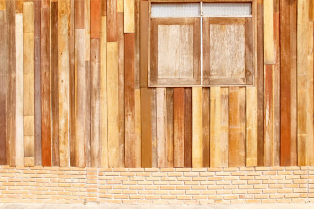 istock Wood house wall brown plank texture  in vertical with window background 1321409557