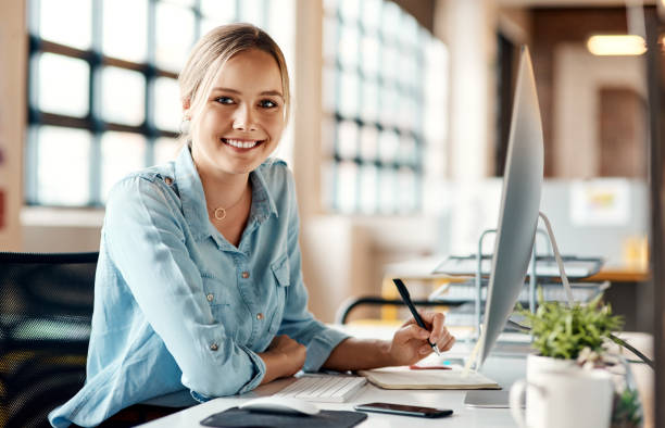 istock Portrait of a young businesswoman using a computer in a modern office 1321409582