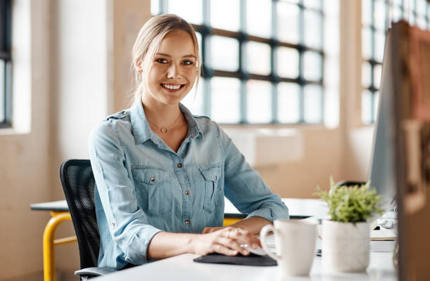 istock Portrait of a young businesswoman using a computer in a modern office 1321409584