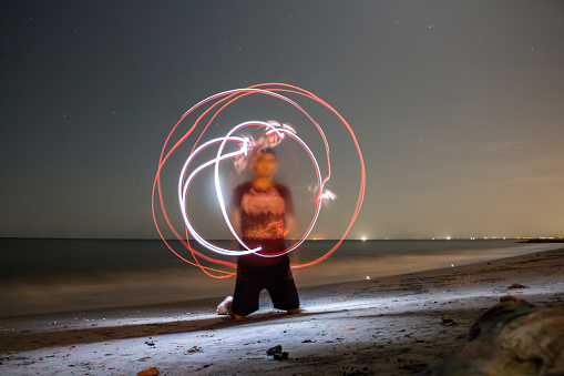 A photo taken with a young at the beach at the night