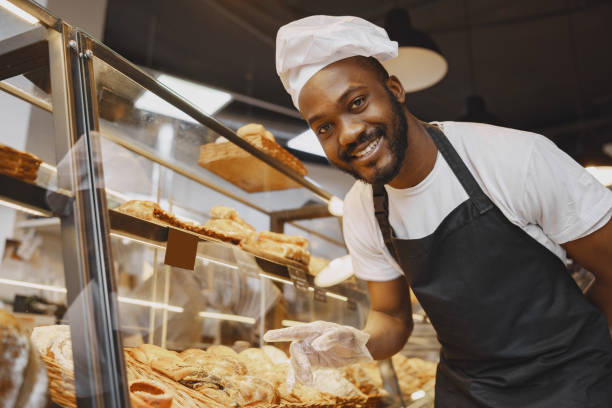 istock Fine African American man in mask offering pastry 1321416751