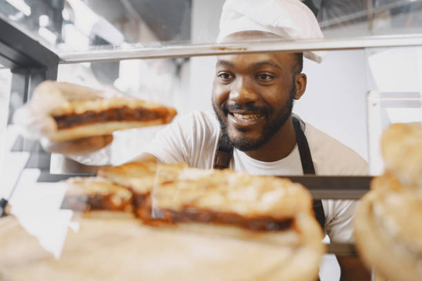 istock Agrican american baker selling buns in cafeteria 1321416763