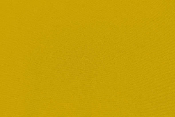 istock Mustard color homogeneous background with a textured surface 1321418819