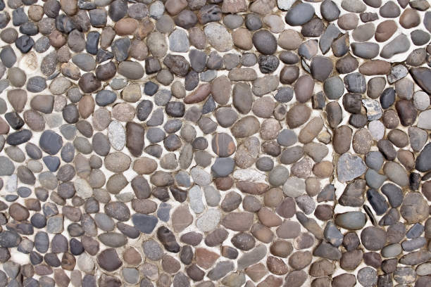 istock Decorative small stone texture on concrete wall brown floor old  background 1321421245