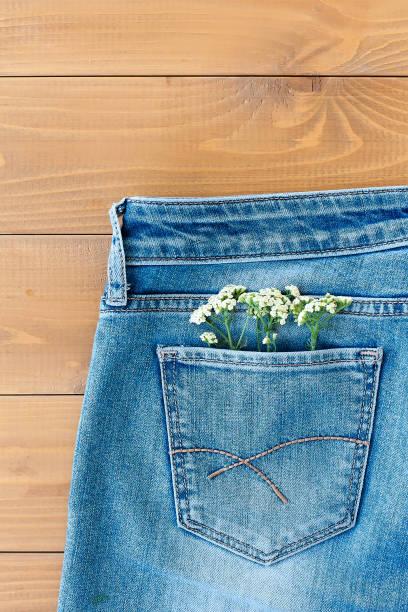 istock Composition with daisies on a blue background for a card or decor. Seven daisies on a denim 1321421488