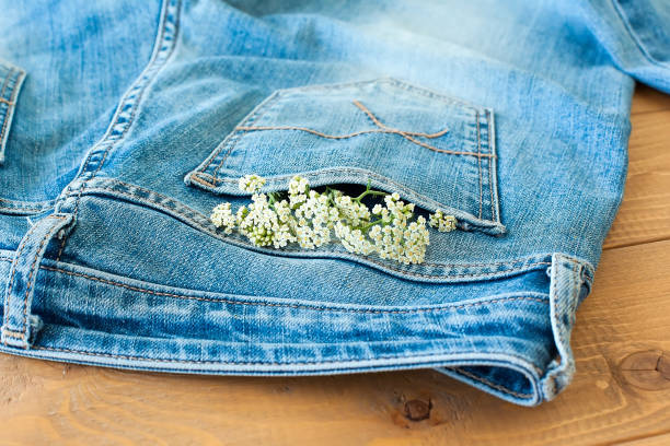 istock Composition with daisies on a blue background for a card or decor. Seven daisies on a denim 1321421529