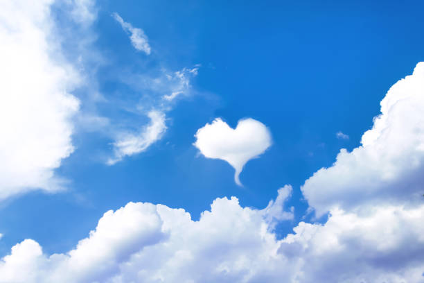 istock White clouds heart shape design close up on vast bright blue sky summer background 1321422402