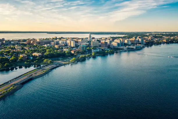 Aerial panorama of Madison downtown at sunset, view above the lake with road leading to the city