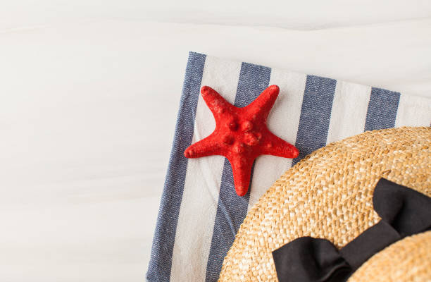 istock A straw hat and a starfish on a light background. Summer background. Copy space. 1321423569