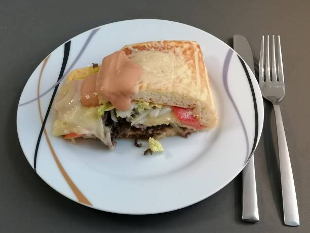 istock Minced meat roll with lettuce, tomatoes and cheese 1321425067