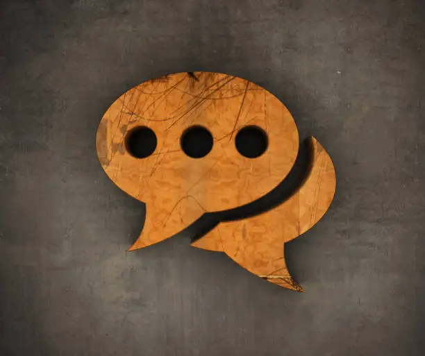 Photo of Wooden Speech Bubble Symbol on The Wall