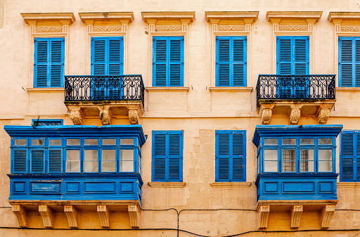 A house with colourful wooden balconies in La Valletta, Malta, typical of the traditional Maltese architecture.