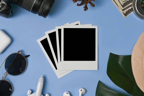 istock Blank photo frame, camera, cup and sunglasses on blue background. 1321428478