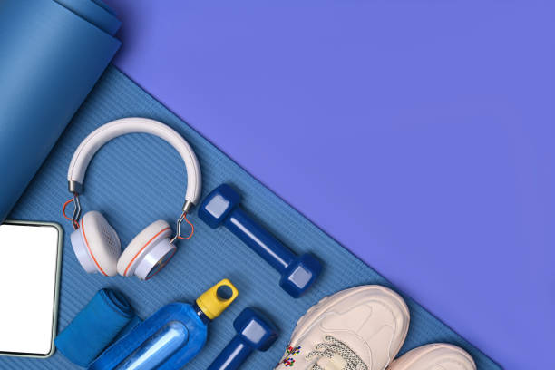 istock Fitness equipment and smart phone on blue mat. 1321428545