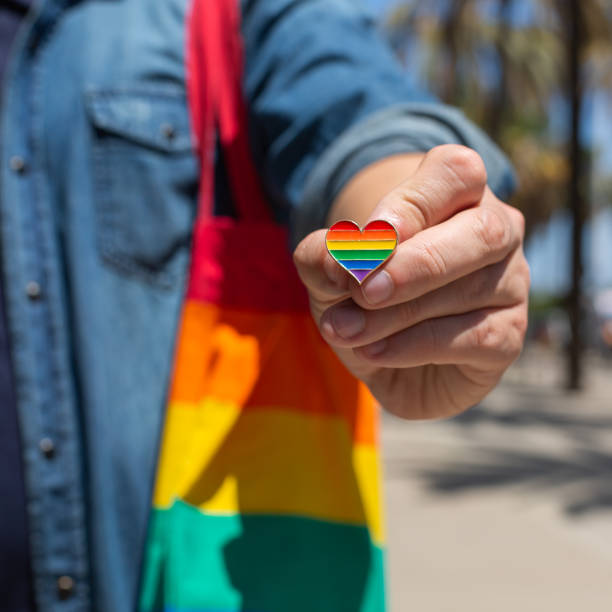istock Man with rainbow reusable bag and lgbt badge, pride month 1321429593