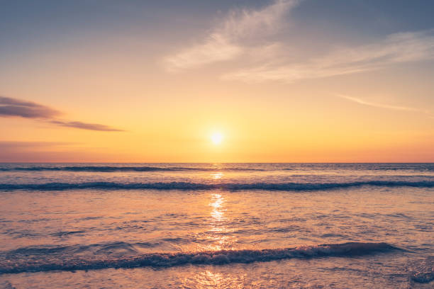 istock Tropical beach with smooth wave and sunset sky abstract background. 1321431453