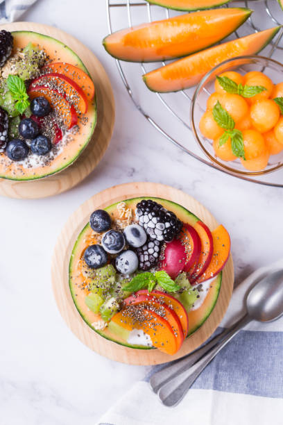 istock Fruit salad with yogurt in carved melon cantaloupe bowl 1321432860