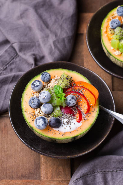 istock Fruit salad with yogurt in carved melon cantaloupe bowl 1321432877