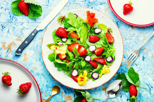 istock Summer salad with berries and herbs,top view 1321432890