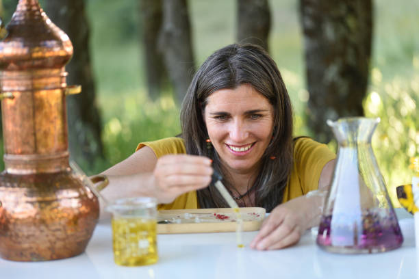 istock Naturopath working with essential oils and flowers in the open air 1321433654