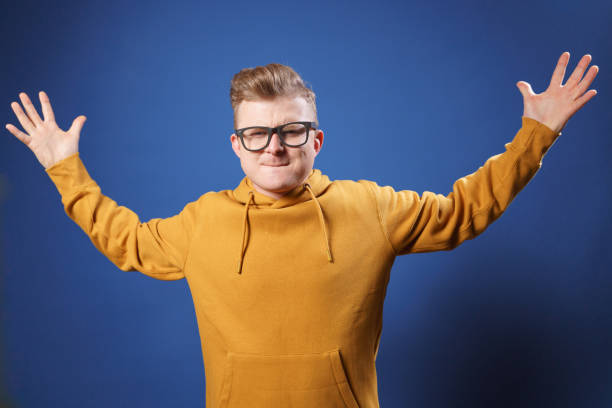 istock Young man showing big size gesture with hands, emphasizing great amount of something 1321433845