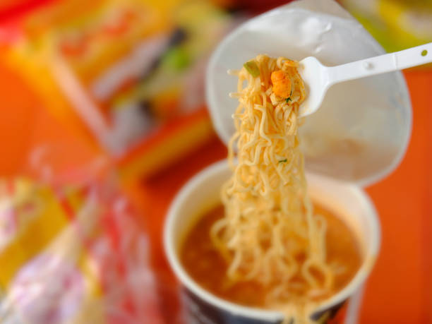 istock Hot, ready to eat, Asian instant cup noodles on the plastic fork that comes with the cup. 1321434817