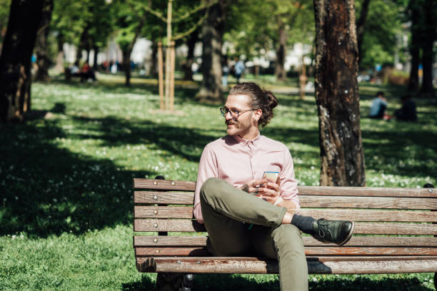 istock Young man enjoying in the park and using smartphone 1321439917