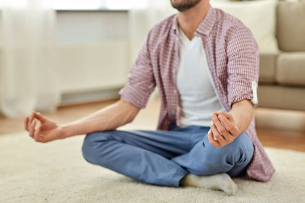 istock close up of man meditating at home 1321444300