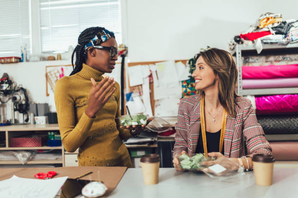 istock Fashion designers working in atelier and making short breakfast break at work 1321449970