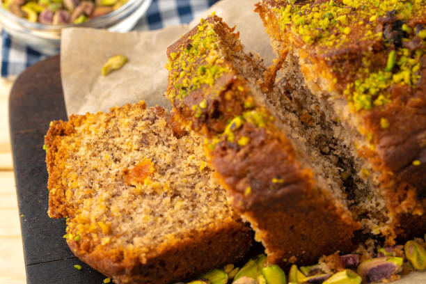 istock Sponge cake with pistachio on wooden board 1321450620