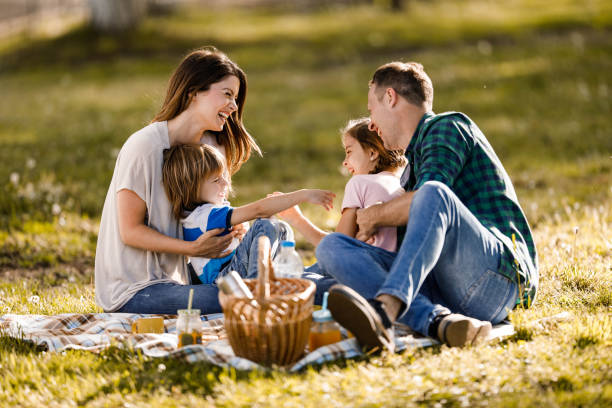 istock Cheerful family communicating in spring day at the park. 1321450718