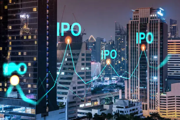 Photo of Initial public offering hologram, night panoramic city view of Bangkok. The financial center for multinational corporations in Asia. The concept of boosting the growth by IPO process. Double exposure.